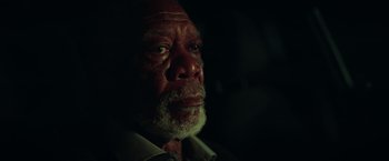 Movie still from “The Ritual Killer” (2023), directed by George Gallo – An older man with a beard and a white shirt; Close Up shot, Low angle