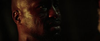 Movie still from “The Ritual Killer” (2023), directed by George Gallo – A man's face in the dark; Extreme Close Up shot, Low angle