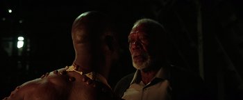 Movie still from “The Ritual Killer” (2023), directed by George Gallo – An older man standing next to a younger man; Close Up shot, Low angle