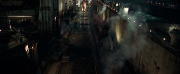 Movie still from “The Ritual Killer” (2023), directed by George Gallo – Smoke billows out of a train tunnel at night; Extreme Wide shot, High angle