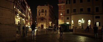 Movie still from “The Ritual Killer” (2023), directed by George Gallo – A couple of people standing on top of a brick road; Extreme Wide shot, Low angle