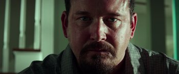 Movie still from “The Ritual Killer” (2023), directed by George Gallo – A person with a beard; Close Up shot, Low angle