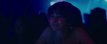 Movie still from “The Royal Hotel” (2023), directed by Kitty Green – A person wearing a black shirt; Close Up shot, Over the shoulder angle