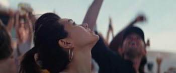 Movie still from “The Royal Hotel” (2023), directed by Kitty Green – A woman with her mouth open looking up at the sky; Close Up shot, Low angle