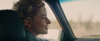 Movie still from “The Royal Hotel” (2023), directed by Kitty Green – A young woman sitting in the passenger seat of a car; Close Up shot, Over the shoulder angle