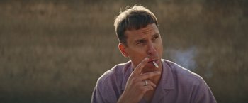 Movie still from “The Royal Hotel” (2023), directed by Kitty Green – A person smoking a cigarette; Close Up shot, High angle