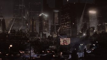 Movie still from “The Running Man” (1987), directed by Paul Michael Glaser – An image of a night time city with lights and buildings; Extreme Wide shot, High angle