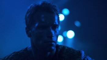 Movie still from “The Running Man” (1987), directed by Paul Michael Glaser – A person in a dark room; Close Up shot, Low angle