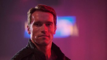 Movie still from “The Running Man” (1987), directed by Paul Michael Glaser – A person wearing a black shirt; Close Up shot, Low angle