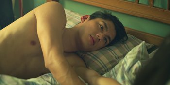 Movie still from “The Sadness” (2021), directed by Rob Jabbaz – A man laying in bed with his arms crossed; Close Up shot, Overhead angle