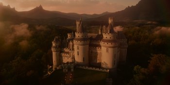 Movie still from “The School for Good and Evil” (2022), directed by Paul Feig – An aerial view of a castle with a sky background; Extreme Wide shot, High angle