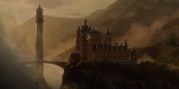 Movie still from “The School for Good and Evil” (2022), directed by Paul Feig – A castle on top of a mountain with a bridge; Extreme Wide shot, Low angle