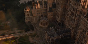 Movie still from “The School for Good and Evil” (2022), directed by Paul Feig – An aerial view of an old building with a clock tower; Extreme Wide shot, High angle