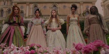 Movie still from “The School for Good and Evil” (2022), directed by Paul Feig – A group of young women in dresses standing next to each other in front of a building; Wide shot, Low angle