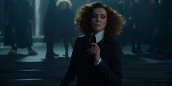 Movie still from “The School for Good and Evil” (2022), directed by Paul Feig – A woman with red hair holding a cell phone in her hand; Medium shot, Low angle