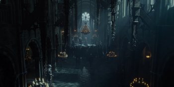 Movie still from “The School for Good and Evil” (2022), directed by Paul Feig – A large cathedral with a lot of lights in the ceiling; Extreme Wide shot, High angle