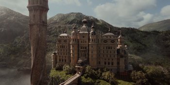 Movie still from “The School for Good and Evil” (2022), directed by Paul Feig – A castle like building with many domed windows and domes; Extreme Wide shot, Low angle