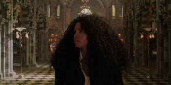Movie still from “The School for Good and Evil” (2022), directed by Paul Feig – A woman with long black hair standing in a room; Close Up shot, Low angle
