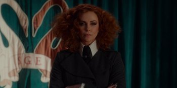 Movie still from “The School for Good and Evil” (2022), directed by Paul Feig – A woman with red hair wearing a suit and tie; Close Up shot, Over the shoulder angle