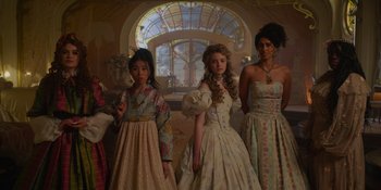 Movie still from “The School for Good and Evil” (2022), directed by Paul Feig – A group of young girls in fancy dresses in front of a stained glass window; Medium shot, Low angle