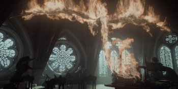 Movie still from “The School for Good and Evil” (2022), directed by Paul Feig – A fire is burning in a cathedral like setting; Extreme Wide shot, Low angle