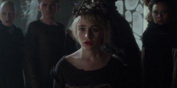 Movie still from “The School for Good and Evil” (2022), directed by Paul Feig – A young woman wearing a crown in a dark room; Close Up shot, Over the shoulder angle