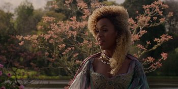 Movie still from “The School for Good and Evil” (2022), directed by Paul Feig – A woman in a long dress with a long necklace; Close Up shot, Over the shoulder angle