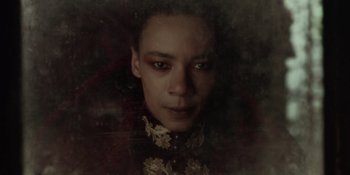 Movie still from “The School for Good and Evil” (2022), directed by Paul Feig – A young man with green and red eyes; Close Up shot, Low angle