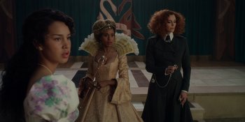 Movie still from “The School for Good and Evil” (2022), directed by Paul Feig – A group of women in fancy dresses standing next to each other; Medium shot, Over the shoulder angle