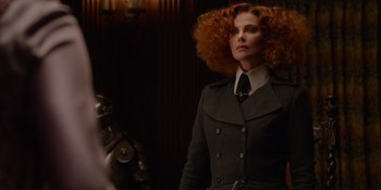 Movie still from “The School for Good and Evil” (2022), directed by Paul Feig – A woman with red curly hair in a suit and tie; Medium shot, Over the shoulder angle