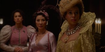 Movie still from “The School for Good and Evil” (2022), directed by Paul Feig – Two women dressed up in fancy costumes and hats; Close Up shot, Over the shoulder angle