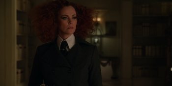 Movie still from “The School for Good and Evil” (2022), directed by Paul Feig – A woman with red hair wearing a suit and tie; Close Up shot, Over the shoulder angle