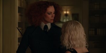 Movie still from “The School for Good and Evil” (2022), directed by Paul Feig – A woman with red hair is talking to another woman in a room; Close Up shot, Over the shoulder angle
