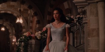 Movie still from “The School for Good and Evil” (2022), directed by Paul Feig – A woman in a white ball gown standing next to flowers; Medium shot, Over the shoulder angle