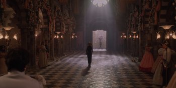 Movie still from “The School for Good and Evil” (2022), directed by Paul Feig – A woman walking down a hall way in a castle; Extreme Wide shot, Over the shoulder angle
