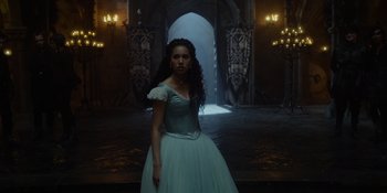 Movie still from “The School for Good and Evil” (2022), directed by Paul Feig – A woman in a blue dress standing in front of an archway; Medium shot, Low angle