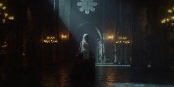 Movie still from “The School for Good and Evil” (2022), directed by Paul Feig – A woman standing in the middle of a dark room; Wide shot, Low angle