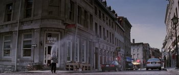 Movie still from “The Score” (2001), directed by Frank Oz – A person standing on the side of the street near a building; Extreme Wide shot, Low angle