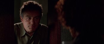 Movie still from “The Score” (2001), directed by Frank Oz – A person looking at another person; Close Up shot, Over the shoulder angle