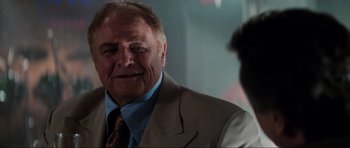 Movie still from “The Score” (2001), directed by Frank Oz – An older man wearing a suit and tie; Close Up shot, Over the shoulder angle