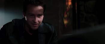 Movie still from “The Score” (2001), directed by Frank Oz – A man in a leather jacket sitting in front of a window; Close Up shot, Over the shoulder angle