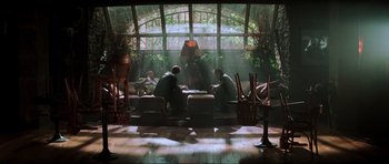 Movie still from “The Score” (2001), directed by Frank Oz – Two men are sitting on a couch in a room; Wide shot, High angle