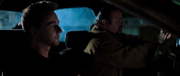 Movie still from “The Score” (2001), directed by Frank Oz – Two men sitting in the back seat of a car at night; Close Up shot, Over the shoulder angle