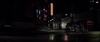 Movie still from “The Score” (2001), directed by Frank Oz – A motorcycle parked on the side of the road at night; Extreme Wide shot, High angle
