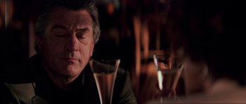 Movie still from “The Score” (2001), directed by Frank Oz – A person sitting in front of a glass; Close Up shot, Over the shoulder angle