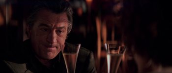 Movie still from “The Score” (2001), directed by Frank Oz – A person sitting in front of a glass; Close Up shot, Over the shoulder angle