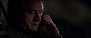 Movie still from “The Score” (2001), directed by Frank Oz – A person talking on a cell phone; Close Up shot, Low angle