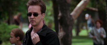 Movie still from “The Score” (2001), directed by Frank Oz – A man in a black shirt and sunglasses is listening to music; Close Up shot, Low angle