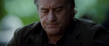 Movie still from “The Score” (2001), directed by Frank Oz – An older man is looking down at his face; Close Up shot, Low angle