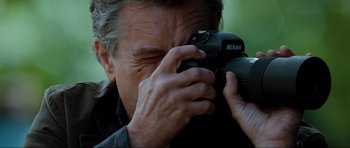 Movie still from “The Score” (2001), directed by Frank Oz – A person taking a picture with a camera; Extreme Close Up shot, Low angle